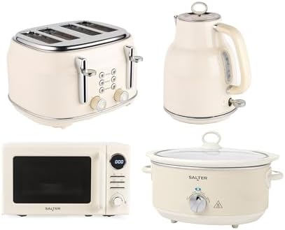 A wide-angle shot of the Salter Retro Cream Kitchen Set including the kettle, toaster, microwave, and slow cooker arranged on a clean kitchen counter.