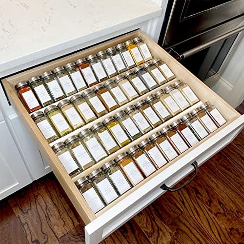 A top-down view of the clear acrylic spice organiser expanded to fit a wide kitchen drawer, filled with neatly arranged spice jars.