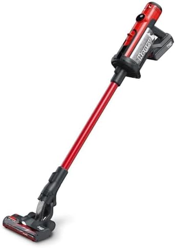 Red cordless vacuum cleaner standing upright on a floor